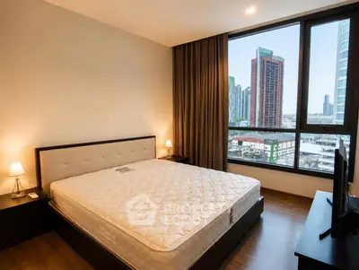 Spacious bedroom with city view in modern apartment