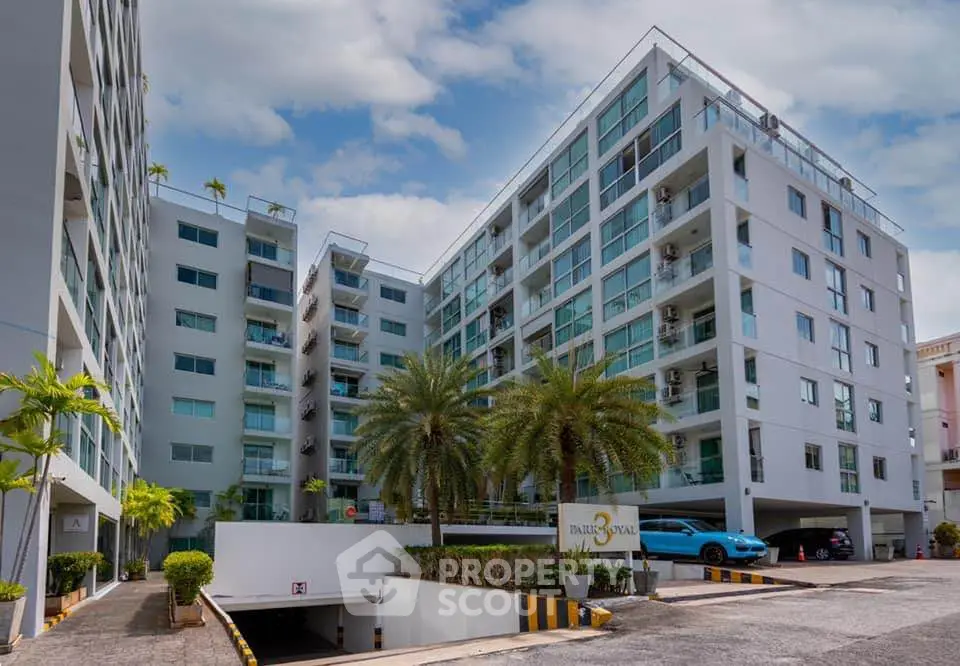 Modern apartment complex with lush landscaping and spacious balconies.