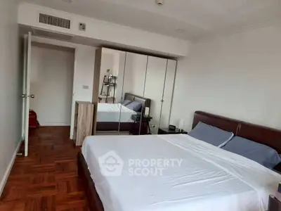 Spacious bedroom with modern furnishings and ample natural light