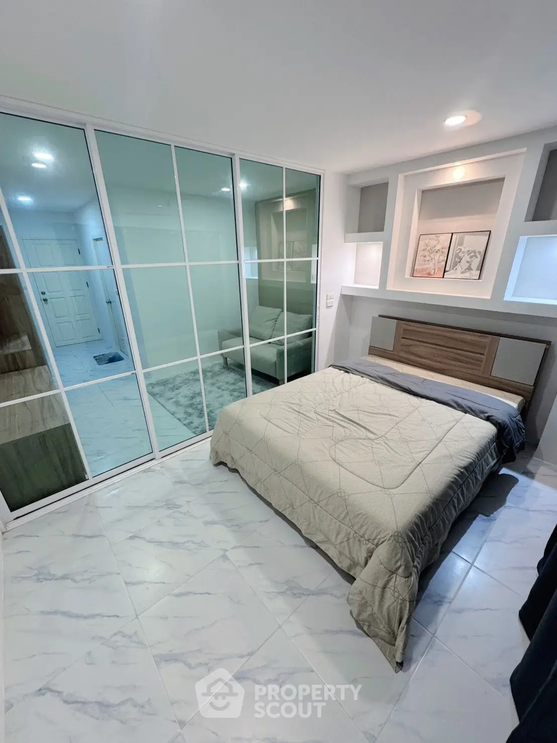 Modern bedroom with sleek mirrored closet and stylish decor