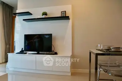 Modern living room with sleek TV unit and dining area
