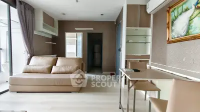 Modern living room with beige sofa, dining table, and stylish decor in a contemporary apartment.