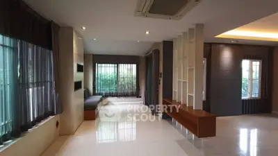 Spacious modern living room with large windows and elegant decor