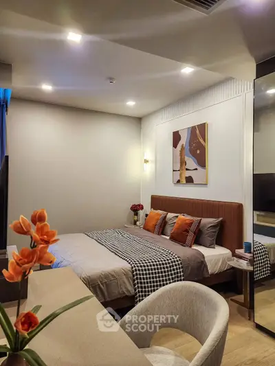 Modern bedroom with stylish decor and cozy ambiance, featuring elegant lighting and contemporary artwork.