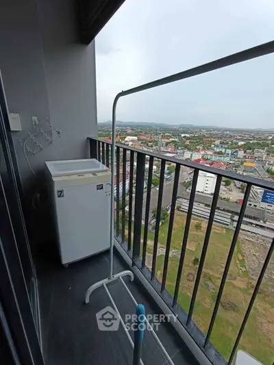 High-rise balcony with washing machine and stunning city view, perfect for urban living.