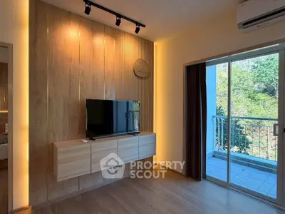 Modern living room with wooden paneling and balcony view