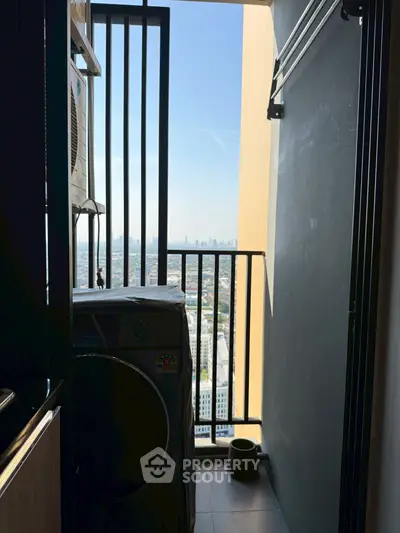 High-rise apartment balcony with city view and laundry area