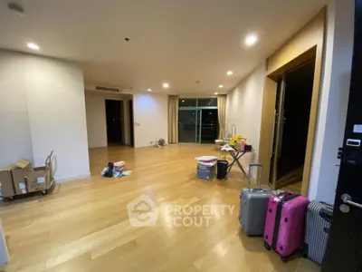 Spacious empty living room with wooden flooring and large windows