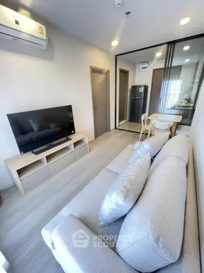 Modern living room with sleek design and open kitchen layout