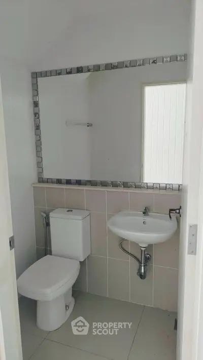 Modern minimalist bathroom with sleek fixtures and large mirror