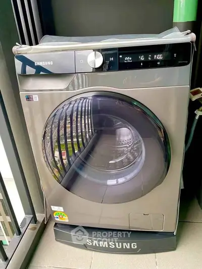 Modern Samsung washing machine on a balcony, showcasing sleek design and advanced features.