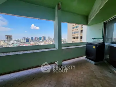 Spacious balcony with stunning city skyline view, perfect for relaxation and enjoying urban living.