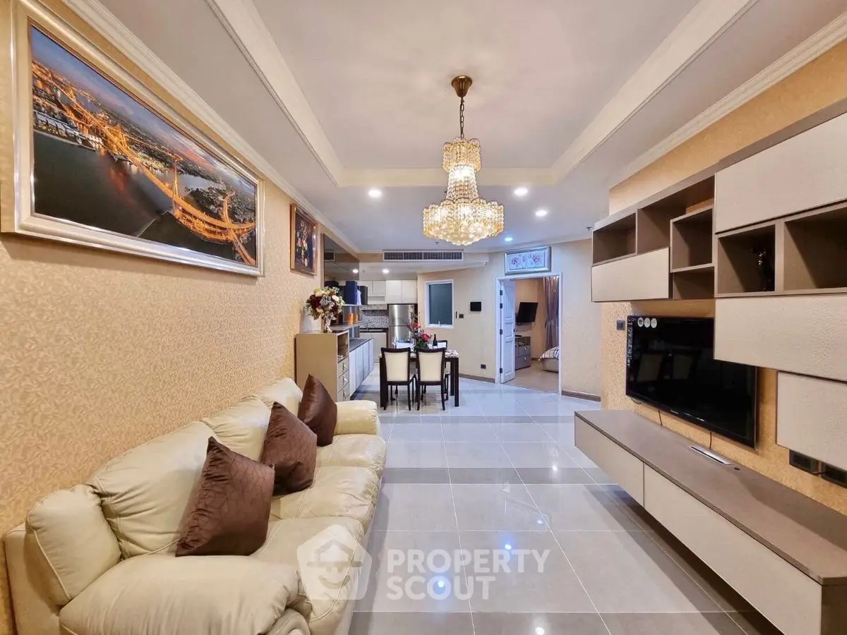 Luxurious living room with elegant chandelier and modern entertainment unit