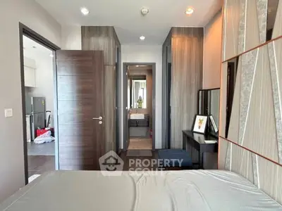 Modern bedroom with stylish decor and ensuite bathroom in a contemporary apartment.