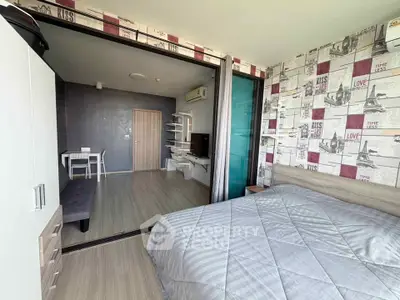 Modern bedroom with stylish decor and sliding glass doors leading to a cozy living area.
