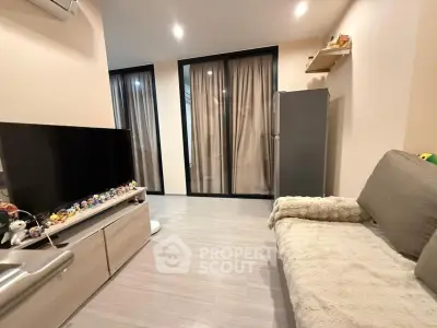 Cozy living room with modern decor and large TV, perfect for relaxation.