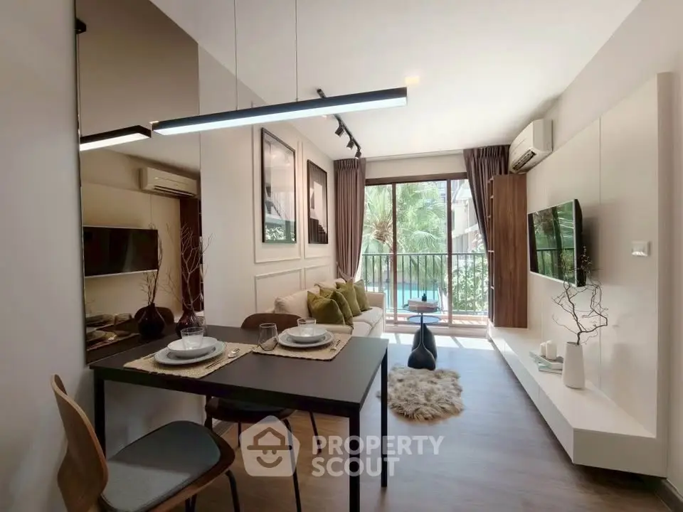 Modern living room with balcony view, stylish decor, and natural light in a cozy apartment.