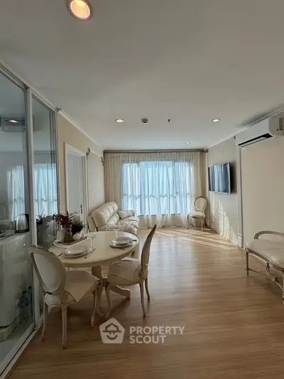 Elegant living room with natural light, stylish furniture, and modern decor