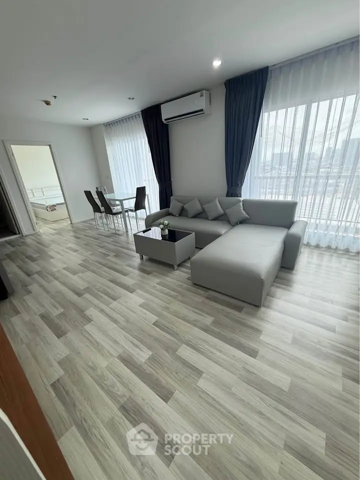 Spacious modern living room with elegant decor and large windows