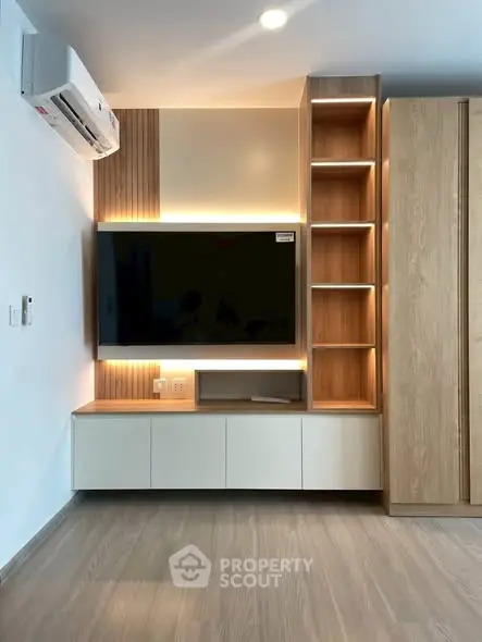 Modern living room with sleek TV unit and wooden flooring