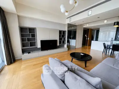 Spacious modern living room with sleek furniture and open kitchen layout, perfect for contemporary living.