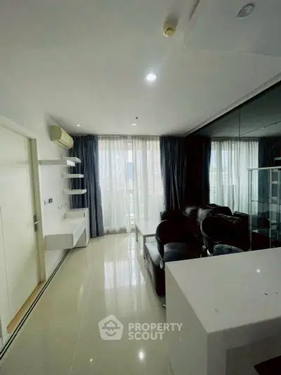 Modern living room with sleek design and large windows offering natural light.