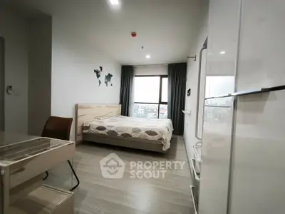 Modern bedroom with city view, stylish decor, and ample natural light.