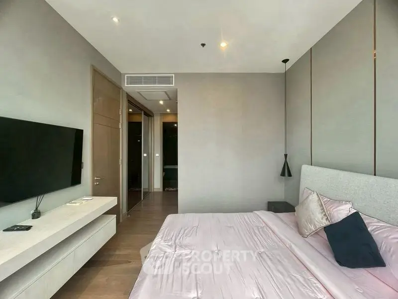 Modern bedroom with sleek design and wall-mounted TV