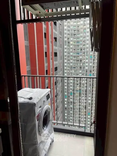 Urban balcony with washing machine and city view, perfect for modern living convenience.