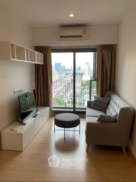 Modern living room with city view, stylish sofa, and wall-mounted storage.