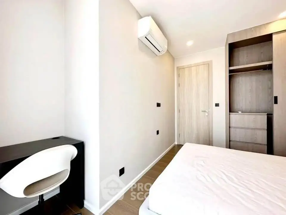 Modern minimalist bedroom with built-in wardrobe and air conditioning