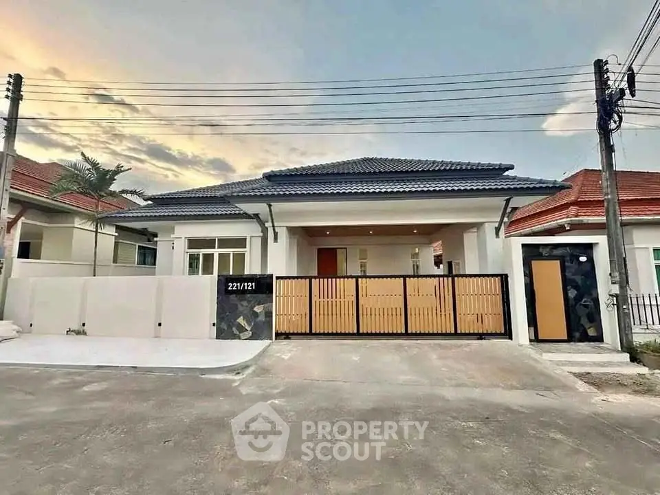 Charming single-story home with modern facade and gated entrance in a serene neighborhood.