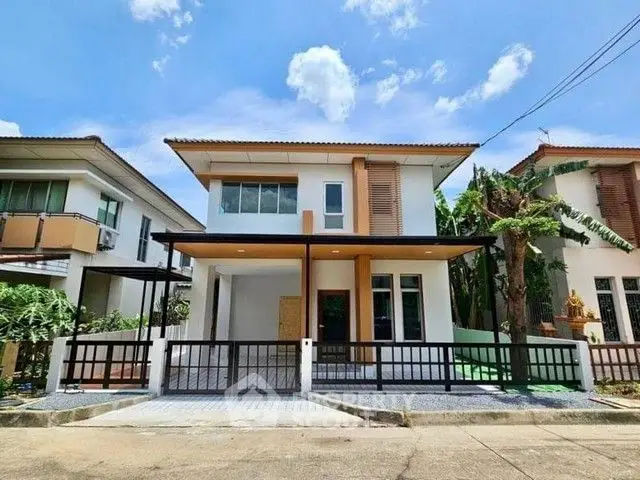 Modern two-story house with sleek design and spacious front yard