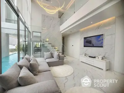 Luxurious modern living room with high ceilings and pool view, featuring elegant marble flooring and stylish decor.