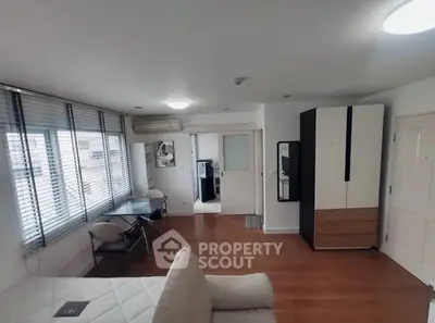 Modern studio apartment with wooden flooring and stylish furniture