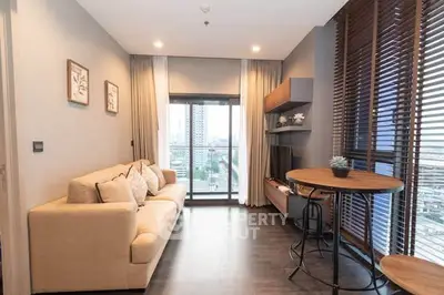 Modern living room with cozy sofa and city view balcony, perfect for relaxation.