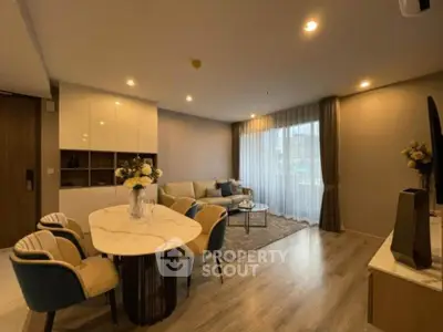 Elegant living room with modern decor, cozy seating, and stylish dining area, perfect for relaxation and entertaining.