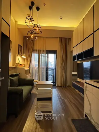 Modern living room with stylish lighting and balcony view in a cozy apartment.