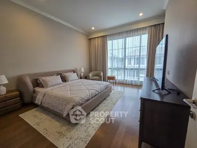 Spacious modern bedroom with large window and stylish decor