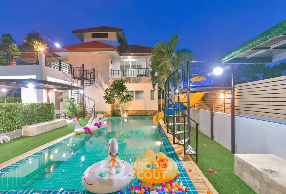 Luxurious villa with private pool and playful inflatables, perfect for family fun and relaxation.