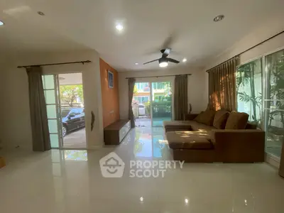 Spacious living room with modern decor and large windows for natural light.