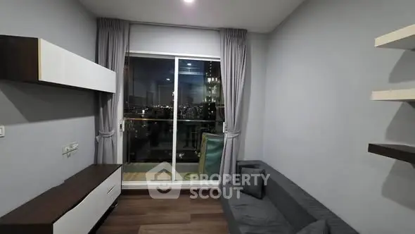Modern living room with sleek furniture and city view from balcony