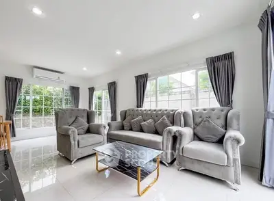 Spacious living room with elegant gray furniture and large windows