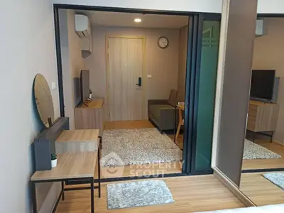 Modern living room with stylish furniture and wooden flooring in a cozy apartment.