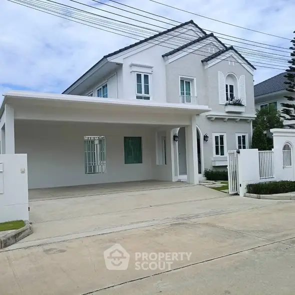 Elegant two-story white house with spacious driveway and modern design.