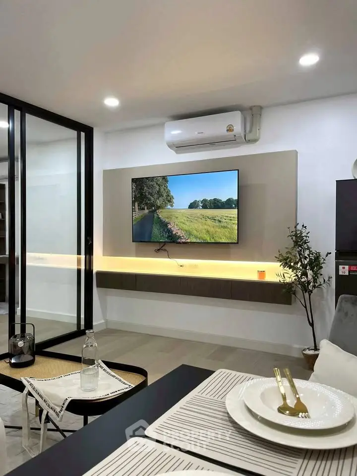 Modern living room with sleek decor and wall-mounted TV