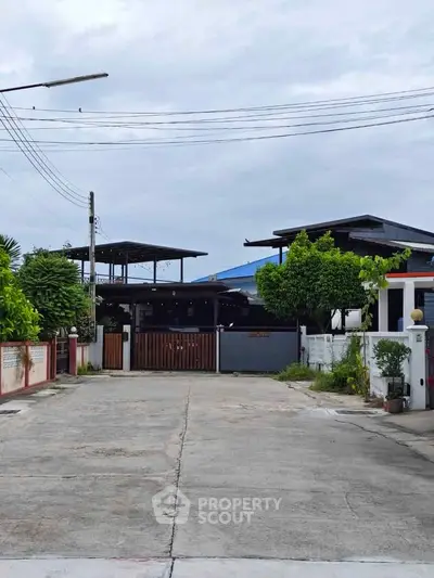 Charming residential property with spacious driveway and lush greenery, perfect for serene living.