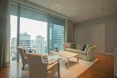 Luxurious high-rise living room with stunning city views and elegant furnishings.