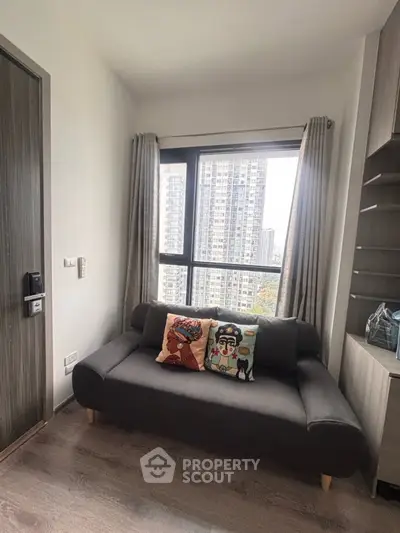 Cozy living room with modern sofa and city view through large window