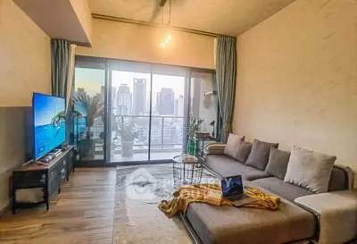 Modern living room with city view and large balcony, featuring stylish decor and comfortable seating.
